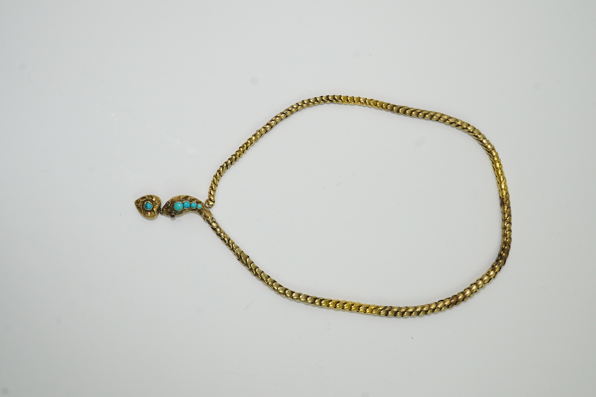 A Victorian gold, turquoise and cabochon garnet set serpent necklace